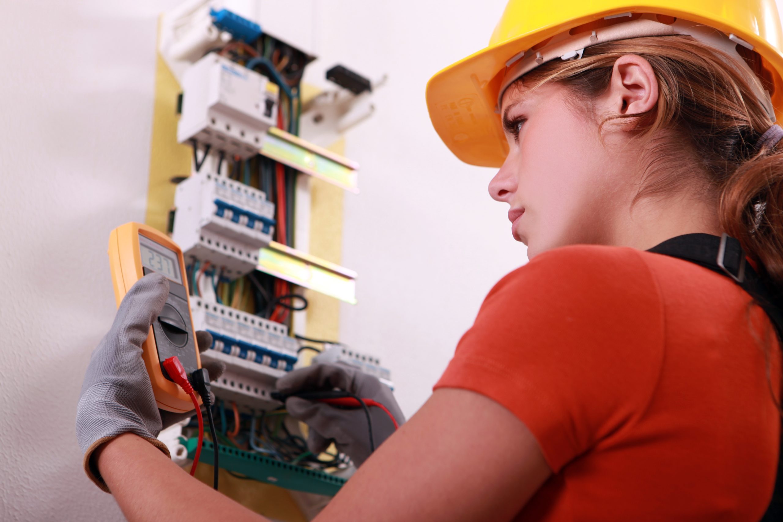 13783058 – woman measuring electrical current