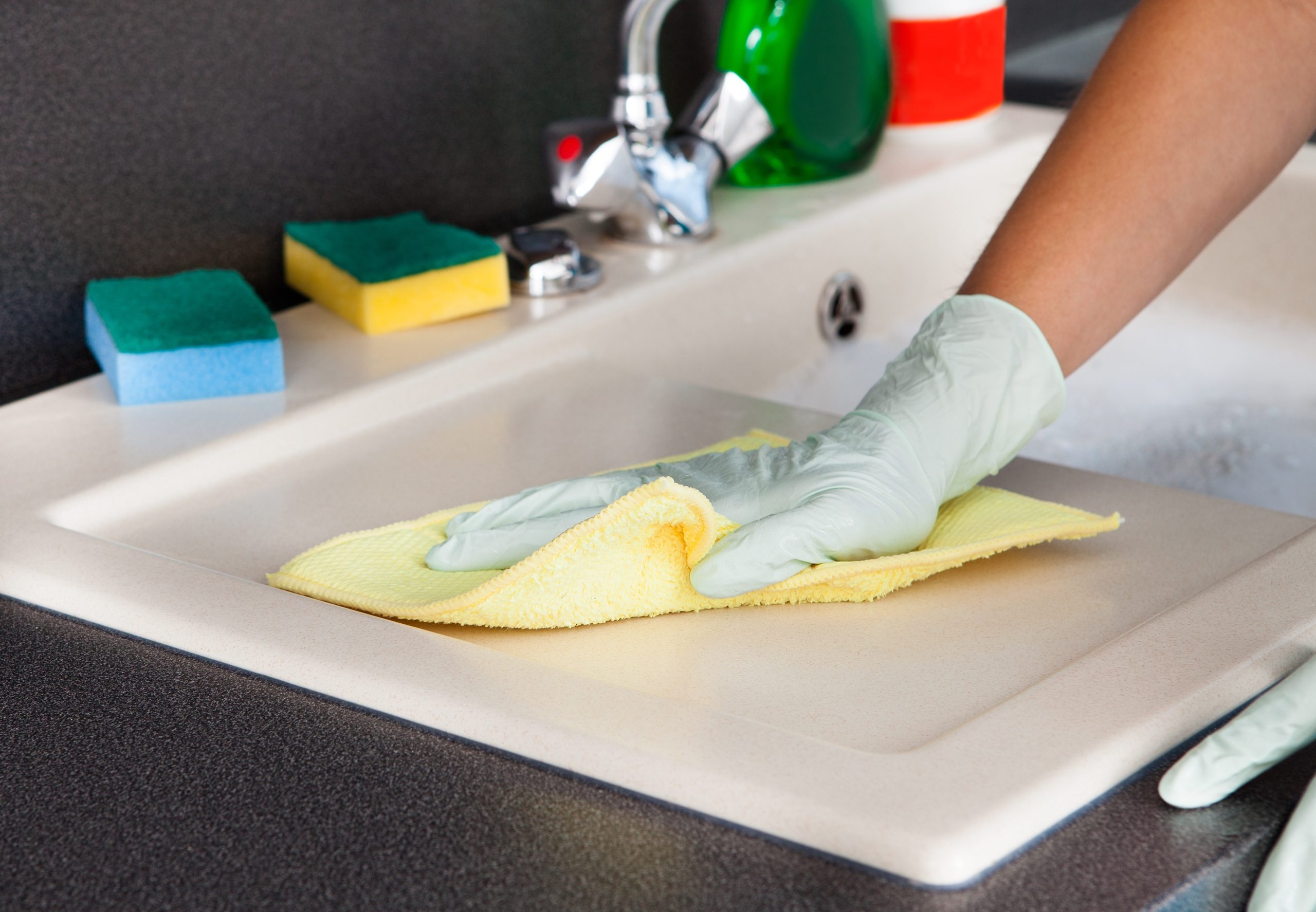 21043918 – portrait of happy woman cleaning kitchen worktop