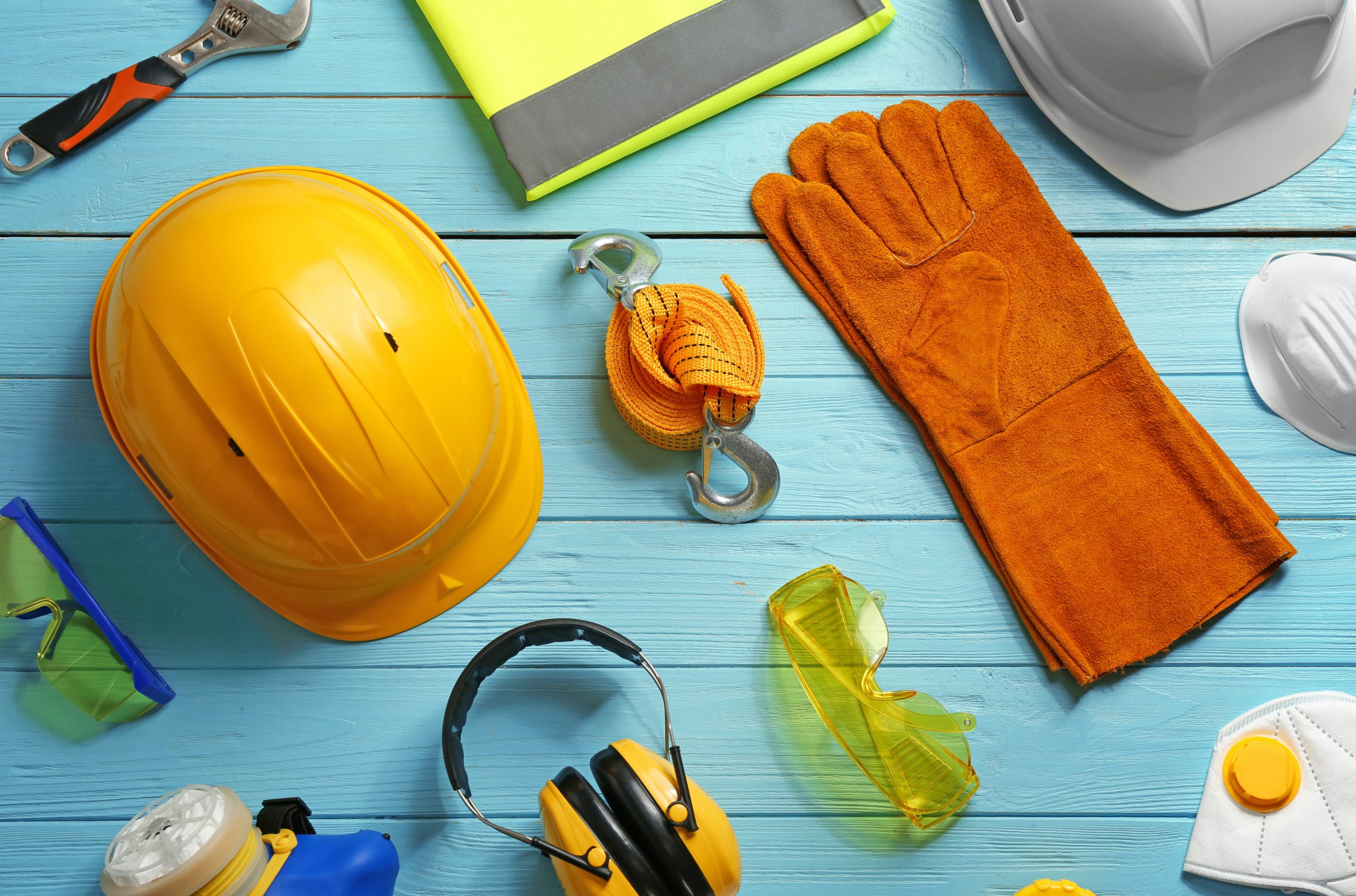 Flat lay composition with safety equipment on wooden background