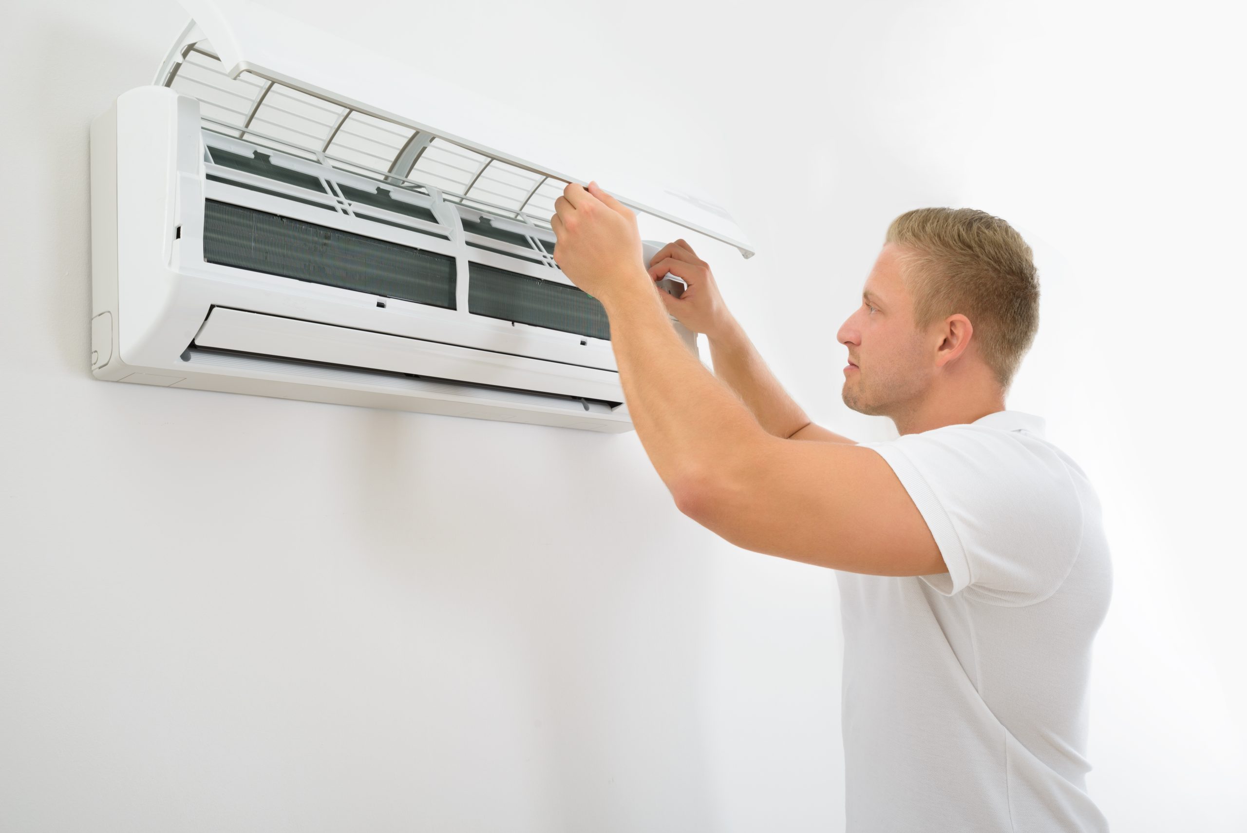 Man Adjusting Air Conditioning System